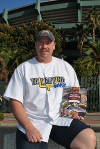 Dave Lamm with Pro Football Cookbook in front of stadium